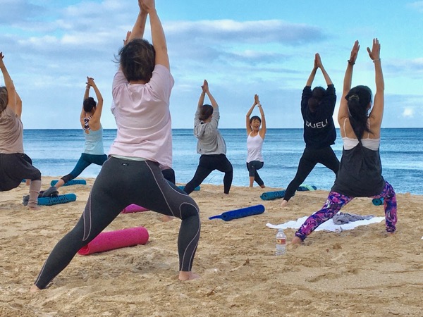 Masumi Muramatsu teaching outdoor yoga at Waikiki Beach, Hawaii