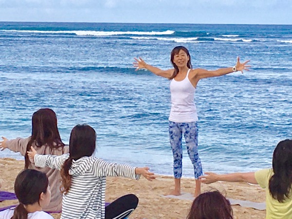 Masumi Muramatsu teaching outdoor yoga at Waikiki Beach, Hawaii