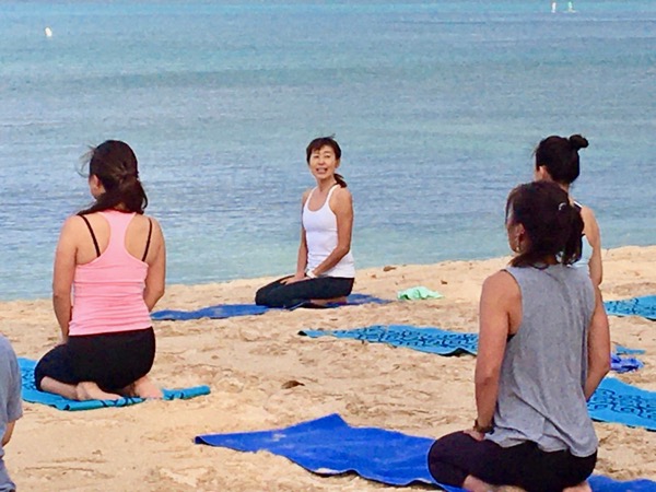 Masumi Muramatsu teaching outdoor yoga at Waikiki Beach, Hawaii