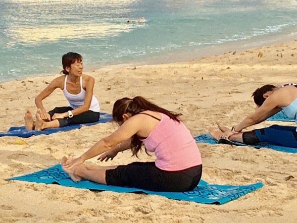 Masumi Muramatsu teaching outdoor yoga at Waikiki Beach, Hawaii