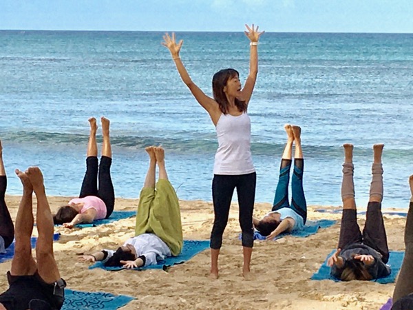 Masumi Muramatsu teaching outdoor yoga at Waikiki Beach, Hawaii