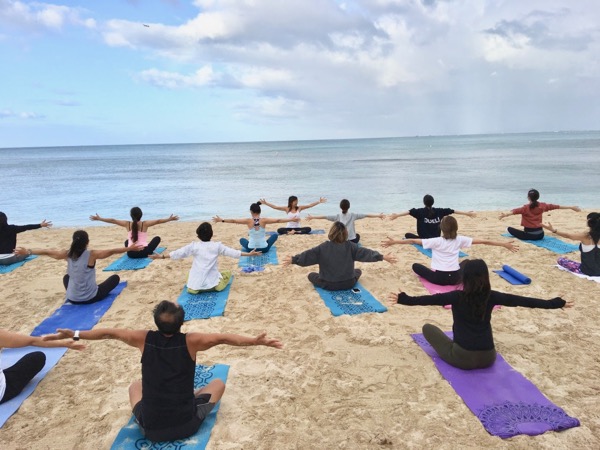 Masumi Muramatsu teaching outdoor yoga at Waikiki Beach, Hawaii